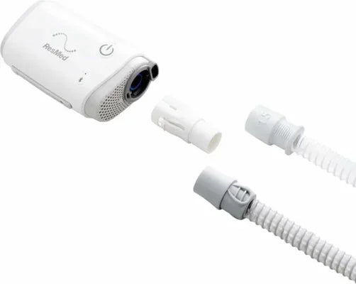Portable CPAP machine with hose adapter and tubes for sleep apnea therapy