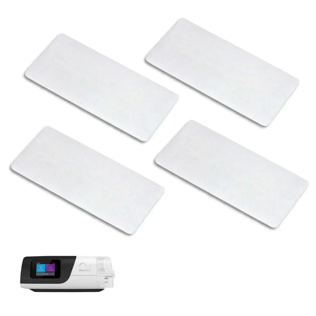 Four white CPAP machine filters with a CPAP device for sleep apnea supplies