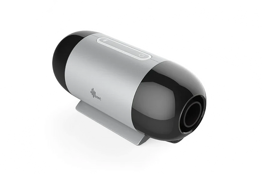 A sleek, cylindrical travel cpap machine with a metallic silver body, glossy black end caps, and a small gray stand, shown on a clean white background.