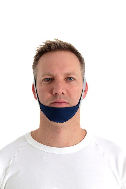 Man wearing a blue CPAP chin strap for sleep apnea therapy on white background