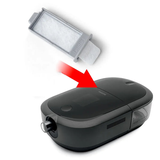 Philips CPAP machine with replacement filter and red arrow indicating filter insertion