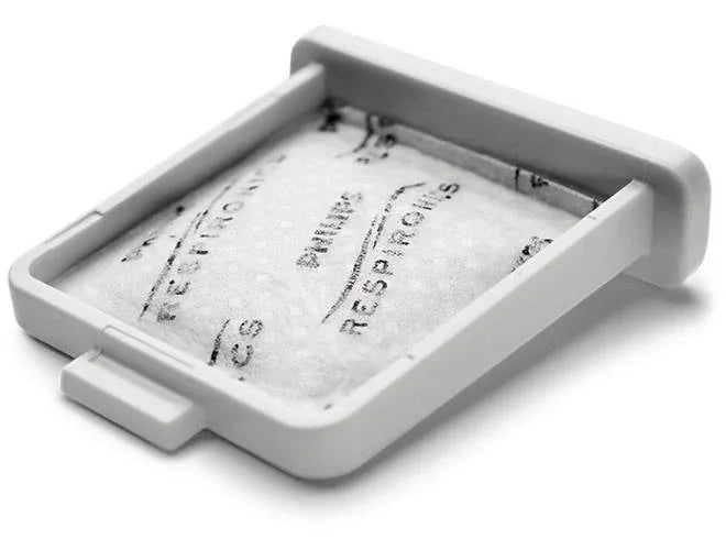 CPAP machine filter in white plastic holder, replacement part for sleep apnea device