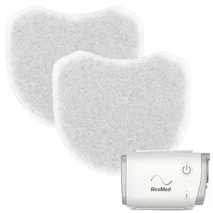 CPAP machine filter replacements with compact white CPAP device on white background