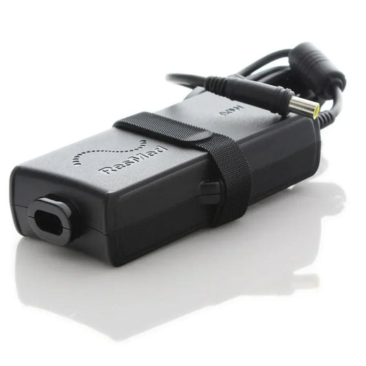 ResMed black CPAP power supply adapter with attached cables on white background
