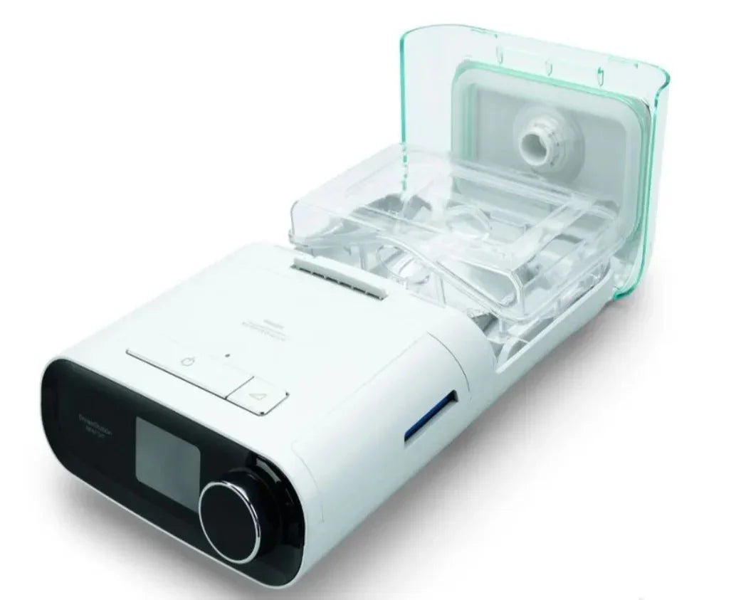 White CPAP machine with digital display and open humidifier chamber for sleep apnea therapy