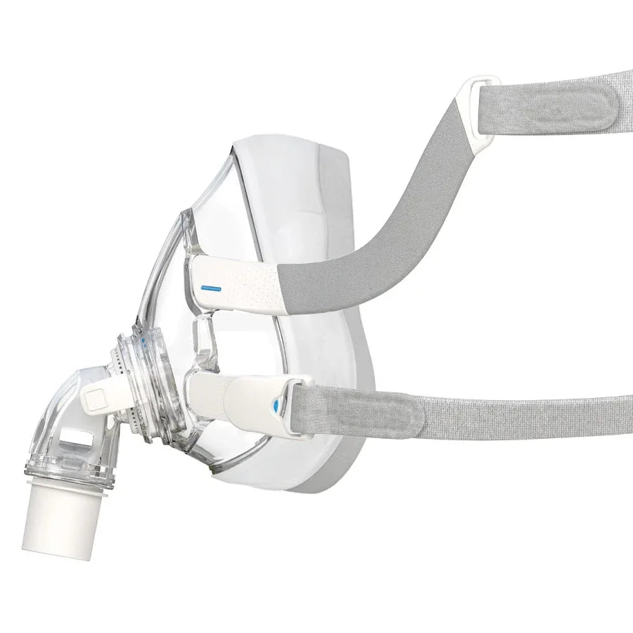 Side view of full face CPAP mask with clear cushion and grey headgear straps