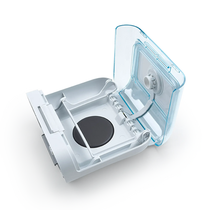 Open CPAP humidifier water chamber with a clear lid and white base