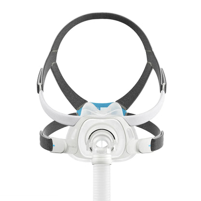 A CPAP mask with a white and gray headband system, featuring a blue accent on the front, shown with an attached white breathing tube against a solid white background.