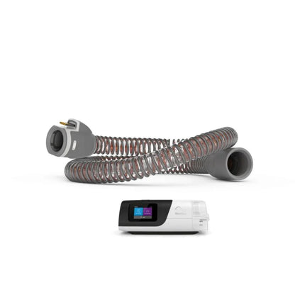 Heated CPAP hose tube and CPAP machine for sleep apnea therapy on white background