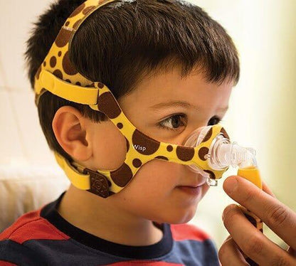 Child wearing giraffe-print CPAP nasal mask for sleep apnea therapy