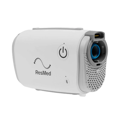 A white and gray ResMed travel CPAP machine shown at a three-quarter angle on a solid white background.