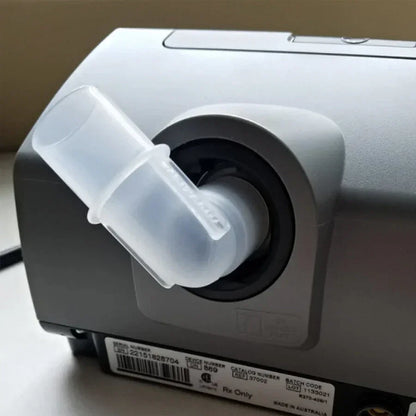 Closeup of the tubing elbow showing where and how it connects to the machine