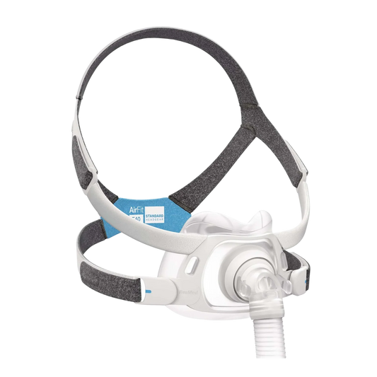 A ResMed F40 CPAP mask with a white plastic facepiece, clear tubing, and a gray and white adjustable headband with a blue and white F40 label.